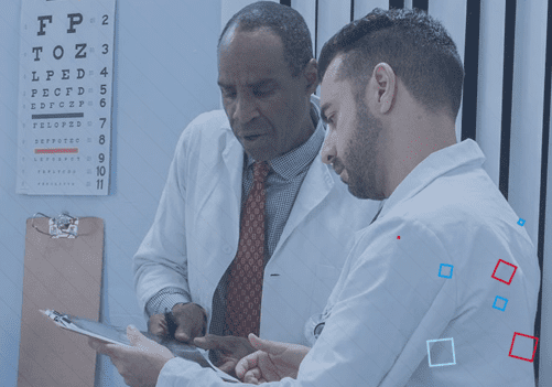 physicians looking at patient chart collaborating together